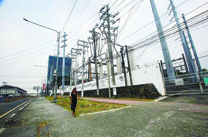 DOE_copy_compressed_resized The Department of Energy says power alerts could persist in the coming months as rising temperatures push electricity demand higher. Photo shows the Manila Electric Company substation along Commonwealth Avenue in Diliman Quezon City. PNA