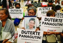 Relatives of war on drugs victims hold placards calling for justice minutes before the start of former President Rodrigo Duterte's hearing on the confirmation of charges on his alleged crimes against humanity case at the International Criminal Court, in this photo taken in Quezon City on February 23, 2026. REUTERS