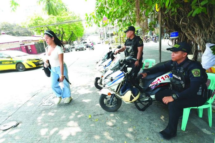 POLICE VISIBILITY. Quezon City Police District officers patrol a major road in Barangay South Triangle, Quezon City. Increased police visibility supports the Department of the Interior and Local Government’s “Safer Cities” program aimed at deterring crime and ensuring public safety. PNA