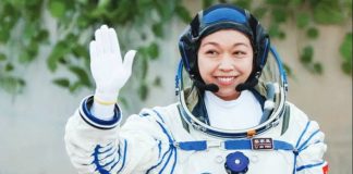 Li Jiaying, Hong Kong’s first astronaut, waves while wearing a full white space. Li Jiaying considers the Shenzhou-23 mission a “rare chance”. REUTERS