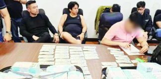 Agents from the National Bureau of Investigation hold an inventory on the seized mixed marked and boodle money amounting to P75 million used to arrest social media personality Franco Mabanta (seated, left) and four others in an entrapment operation at a village in Pasig City on May 5, 2026. CONTRIBUTED PHOTO