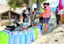 Residents in Barangay Travesia, Guinobatan, Albay, one of the villages reeling from Mayon Volcano’s ashfall, line up for free potable water amid a shortage of supply in the area. MICHAEL B. JAUCIAN | INQUIRER LUZON