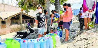 Residents in Barangay Travesia, Guinobatan, Albay, one of the villages reeling from Mayon Volcano’s ashfall, line up for free potable water amid a shortage of supply in the area. MICHAEL B. JAUCIAN | INQUIRER LUZON