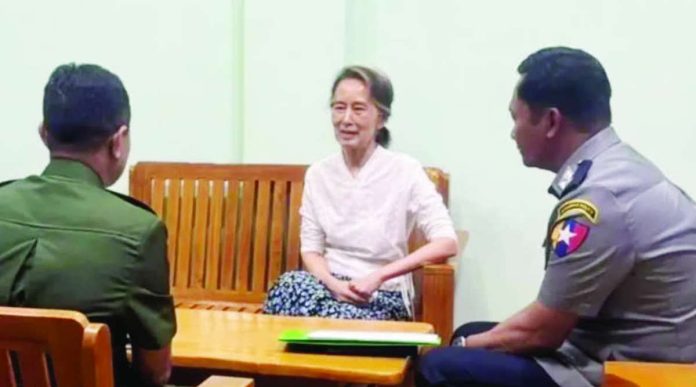 Myanmar_compressed_resized Myanmar state media broadcast a picture of detained former leader Aung San Suu Kyi sitting with two uniformed personnel.