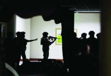 ‘NBI driver’ arrested following Senate gunfire Marine soldiers detailed at the Senate keep their distance from the source of the gunshots that rang out on the second-floor hallway on Wednesday night, May 14, 2026. NIÑO JESUS ORBETA