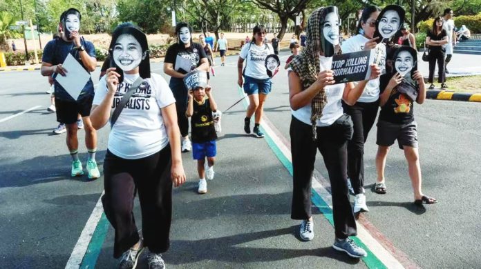 NUJP CONSTITUTIONAL RIGHT. Advocates for press freedom gather at the University of the Philippines in Diliman, Quezon City on May 3, 2026 wearing masks of detained journalist Frenchie Mae Cumpio and slain journalist RJ Ledesma. GRIG C. MONTEGRANDE, PHILIPPINE DAILY INQUIRER