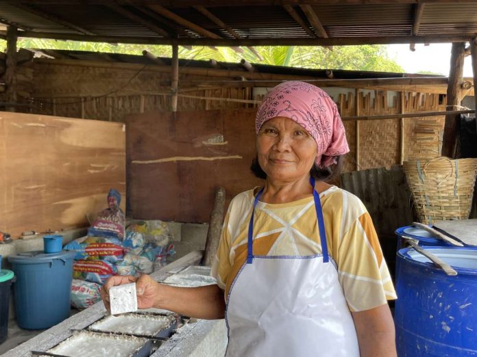 Sherley Padohinog holding the tultul salt finished product. She is the woman behind the traditional production of tultul salt in Barangay Hoskyn, Jordan, Guimaras.