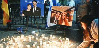 People attend a candlelight vigil for Yaron Lischinsky and Sarah Lynn Milgrim across from the White House in Washington, DC. AFP VIA GETTY IMAGES