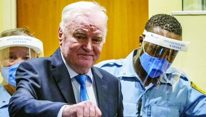 War_criminal_copy_compressed_resized Ex-Bosnian Serb military chief Ratko Mladic arrives in the courtroom prior to the hearing of the final verdict on appeal against his genocide conviction over the 1995 Srebrenica massacre. Mladic has been in detention since 2011 and lost his appeal 10 years later. AFP VIA GETTY IMAGES