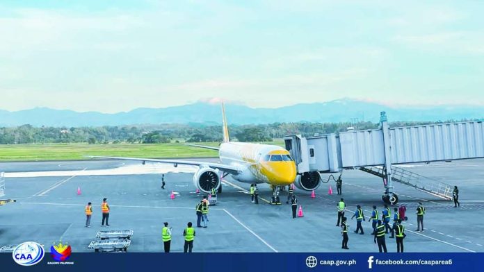 airport_pic_compressed_resized Handling 35 to 40 domestic and international flights daily, terminal facilities at the Iloilo International Airport in Cabatuan, Iloilo struggle to keep pace with peak demand — particularly when four to five aircraft arrive almost simultaneously, each carrying about 200 passengers. Photo shows an international flight from Singapore arriving at the Iloilo International Airport. CAAP AREA VI/FACEBOOK PHOTO