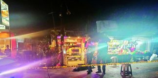 Police officers gather at a cordoned-off section of Purok Mahimulaton, Barangay Banago, Bacolod City, where 39-year-old Victor Hermano was gunned down on Wednesday, May 27, 2026. The victim sustained fatal gunshot wounds and was declared dead at the scene. BCPO PHOTO