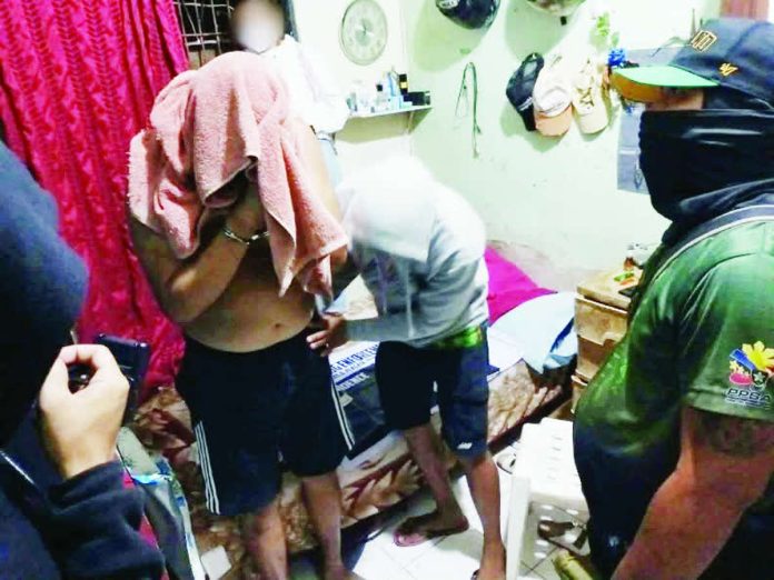 bakhaw_drug_sting_compressed_resized Police operatives performed a body search on alias “JR” during an anti-illegal drugs operation in Barangay Bakhaw, Mandurriao, Iloilo City on May 18. The suspect yielded around P1.5 million worth of suspected shabu. ICPO PHOTO