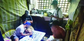 Police operatives inventory plastic sachets of suspected shabu seized from a 34-year-old car painter (right, sitting) during a buy-bust operation in Zone 3, Barangay Barroc, Tigbauan, Iloilo. The operation yielded around 80 grams of illegal drugs valued at P544,000. IPPO PHOTO