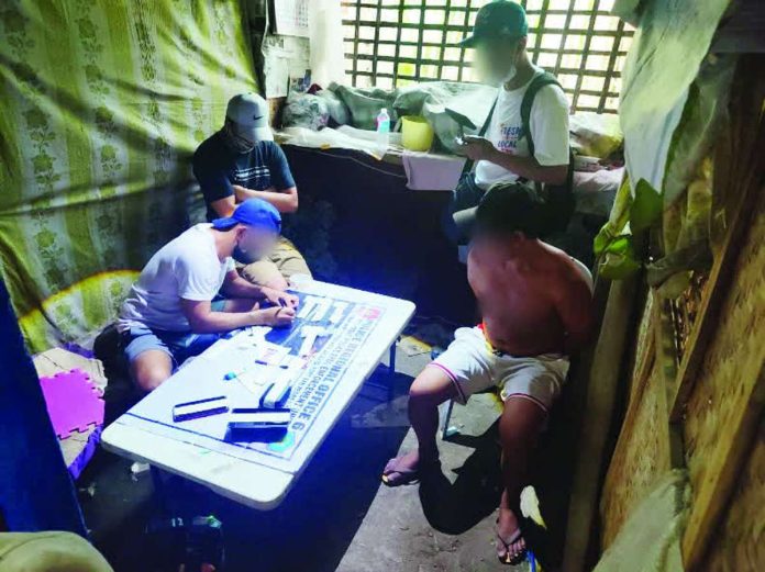 car_painter_compressed_resized_resized Police operatives inventory plastic sachets of suspected shabu seized from a 34-year-old car painter (right, sitting) during a buy-bust operation in Zone 3, Barangay Barroc, Tigbauan, Iloilo. The operation yielded around 80 grams of illegal drugs valued at P544,000. IPPO PHOTO