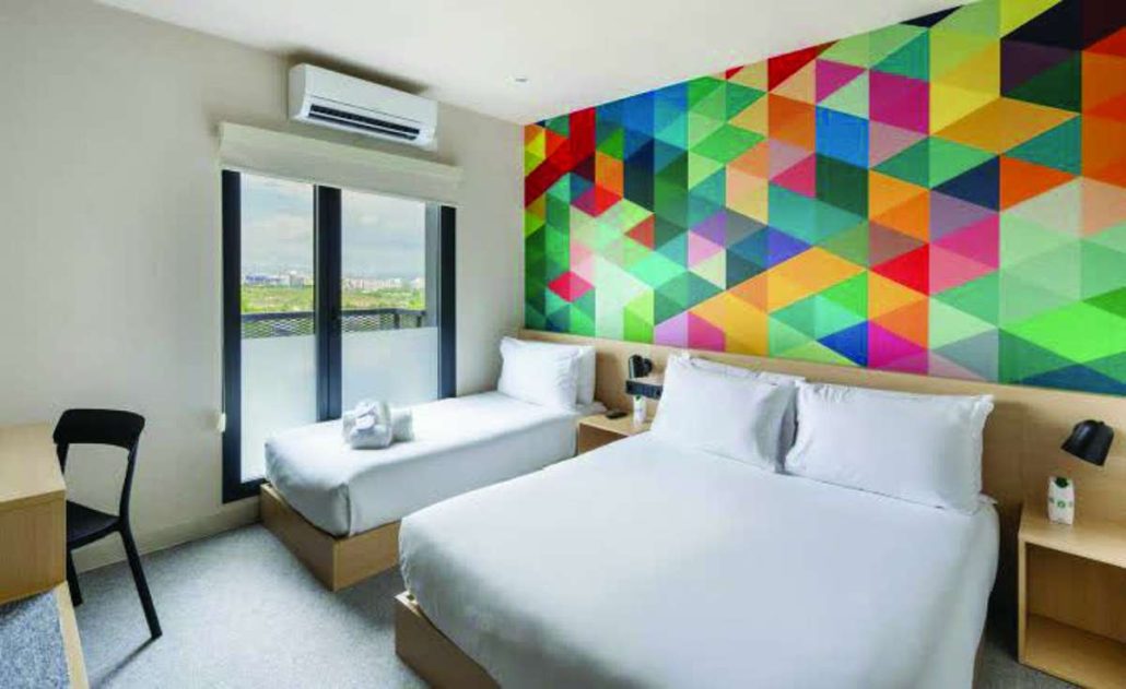 Hotel101’s signature 21-square meter HappyRoom is equipped with a practical kitchenette featuring microwave, refrigerator and kettle; luggage rack, 55” TV, free high-speed internet, work desk, modern bidet toilet, strong water pressure, and premium Emma Sleep mattresses.