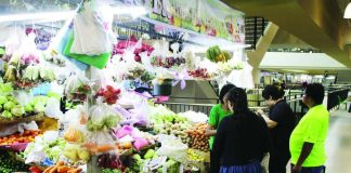 A vegetable vendor at the Iloilo Terminal Market in Iloilo City tends to her customers. AL PALCULLO/PN