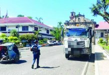 COPS IN ILLEGAL QUARRY TRADE FACE DISMISSAL; PRO-6 chief warns erring police: “Goodbye sa career ninyo’ Police Regional Office-6 director Brigadier General Josefino Ligan (left photo) says police personnel found protecting, facilitating, or directly participating in illegal quarry activities would face both criminal and administrative sanctions. Right photo shows an officer from the Sta. Barbara Municipal Police Station flagging down a dump truck at the town plaza during a province-wide crackdown on illegal quarrying. PRO-6 / IPPO PHOTOS
