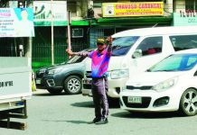 BARANGAY TANODS MAY GAIN TRAFFIC POWERS, but plan raises fears over abuse, politics, accountability A traffic aide directs vehicles along Bonifacio Drive in Iloilo City’s City Proper district. Traffic management in the city is expected to get a boost as the Traffic and Transportation Management Office pushes to deputize barangay officials and tanods to strengthen community-based traffic enforcement and anti-illegal parking efforts. AJ PALCULLO/PN
