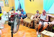 POWER DEMAND SURGES: While temperatures soar, utilities urge WV consumers to practice energy-saving habits A family in Barotac Nuevo, Iloilo utilizes two electric fans inside their home on Tuesday, May 19, seeking relief as summer temperatures continue to soar. As household appliance use spikes due to the intense summer heat, power distributors across Western Visayas report that peak-hour demand is putting a heavy strain on power reserves, prompting calls for strict energy conservation. PN PHOTO