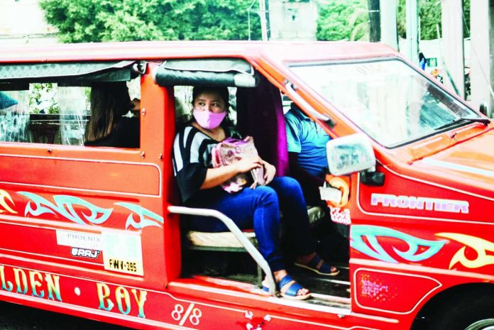 A masked passenger rides a traditional public utility jeepney in Iloilo City as authorities continue to monitor air quality across the metro, which remained under the “good to fair” category based on the Environmental Management Bureau monitoring. The agency, however, reminds vulnerable groups to remain cautious amid changing pollution and weather conditions. PN