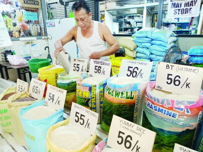 local_rice_SRP_compressed_resized A vendor tends to his array of rice varieties inside the Iloilo Terminal Market in Iloilo City on May 14, 2026. The Department of Agriculture confirms that the full enforcement of the P50 price cap on local rice will begin next week. AJ PALCULLO/PN