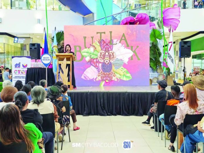 negros_trade_fair_compressed_resized Mary Ann Colmenares, chairperson of the 40th Negros Trade Fair (NTF), says “Butlak” is set to offer “the best of Negros in food, fashion, crafts, and more” at SM Aura Premier in Taguig City on Sept. 22 to 27, 2026. The NTF’s Ruby theme “Butlak” was launched on May 29 as part of “Sibol,” an event that brings together the best of Negrense creativity and craftsmanship. SM CITY BACOLOD/FACEBOOK PHOTO