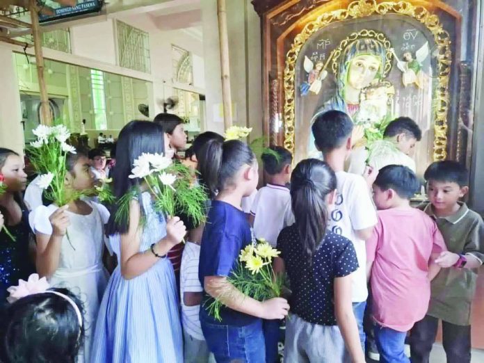 neljoy_Flores1_compressed_resized Flores de Mayo children queue to offer flowers to the icon of Our Lady of Perpetual Help at St. Clement’s Church in La Paz, Iloilo City. NELJOY GALIGAO/PN