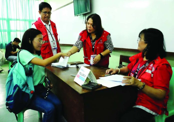 Department of Social Welfare and Development personnel assist a beneficiary during the implementation of the KALAHI-CIDSS program in Western Visayas, one of the community-driven initiatives that have benefitted more than 1.4 million households in the region from 2020 to 2025. DSWD-6