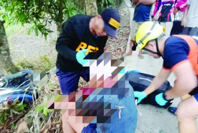 Personnel of the Bureau of Fire Protection (BFP)-Passi City apply first aid to a 27-year-old motorcycle driver who was found unconscious after crashing into a tree in Barangay Cadilang, Passi City, Iloilo early Tuesday morning, May 12. PHOTO BY BFP-PASSI CITY