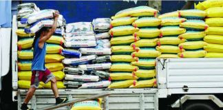 Workers load sacks of imported rice from Thailand and Vietnam on a truck in Dagupan, Manila, for transport to various dealers and distributors. PHILIPPINE DAILY INQUIRER