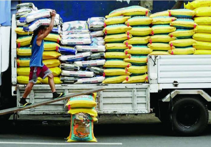 rice_price_cap_copy_compressed_resized Workers load sacks of imported rice from Thailand and Vietnam on a truck in Dagupan, Manila, for transport to various dealers and distributors. PHILIPPINE DAILY INQUIRER