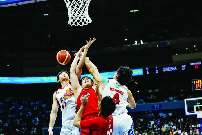 sports_Ginebra_compressed_resized Barangay Ginebra San Miguel Kings center George Isaac Go is swarmed by defenders Christian Manaytay and Michael Malonzo of Rain or Shine Elasto Painters during Game 3 of their PBA Season 50 Commissioner’s Cup semifinal series at the SM Mall of Asia Arena in Pasay City. PBA PHOTO