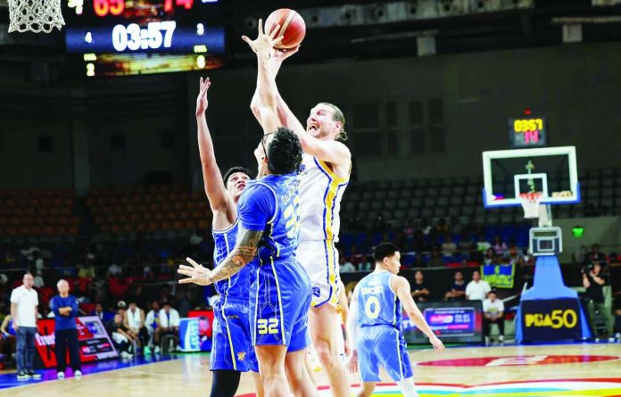 sports_Mag_compressed_resized Magnolia Chicken Timplados Hotshots import Clint Chapman attacks the basket against TNT Tropang 5G’s Henry Galinato during their PBA Season 50 Commissioner’s Cup clash at the Ninoy Aquino Stadium. PBA PHOTO
