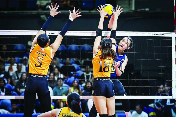 sports_NU_copy_compressed_resized Negrense Arah Panique of National University Lady Bulldogs scores against the defense of University of Santo Tomas Golden Tigresses. UAAP PHOTO