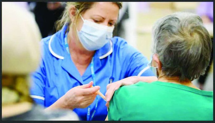 A medical professional is administering an injection to another person’s upper arm. Vaccines play a crucial role in pandemics. GETTY IMAGES