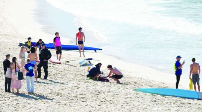 Australia_copy_compressed_resized Police officers speak to people following a shark attack at Coogee Beach in Sydney, Australia. REUTERS