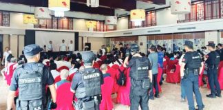 Chinese police officers surround congregants seated on chairs midway through Sunday service at Early Rain Covenant Church. More than 30 members of the church were taken for interrogation. EARLY RAIN COVENANT CHURCH