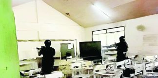 Policemen search a classroom at San Jose National High School after a shooting incident on Monday morning, June 22, that left three students dead and over 10 others injured. Authorities have arrested two suspects. PNA