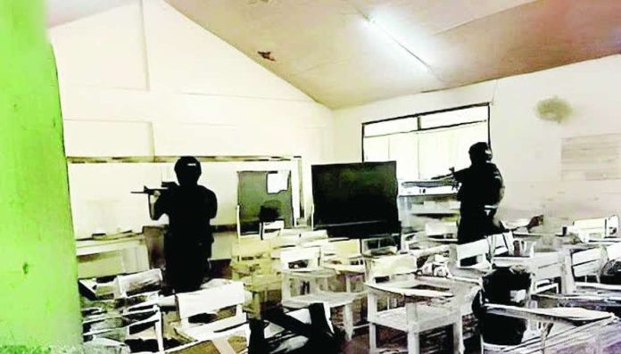 DepEd_review_copy_compressed_resized Policemen search a classroom at San Jose National High School after a shooting incident on Monday morning, June 22, that left three students dead and over 10 others injured. Authorities have arrested two suspects. PNA