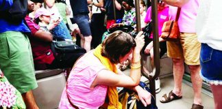 A woman sits on the floor of a crowded carriage on metro line 11 during a heatwave in Paris. The heatwave will be "widespread, long-lasting and intense", France's forecaster warned. GETTY IMAGES