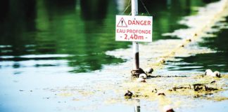 A danger signs warns people at a river in France. The French government says too many people are heading for reservoirs and rivers without taking the risks into account. GETTY IMAGES