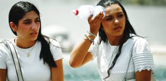 A woman places a bottle filled with ice on her head to cool down at St. Peter’s Square in the Vatican. Temperatures in Italy are yet to peak, with over 40C expected on Monday. GETTY IMAGES