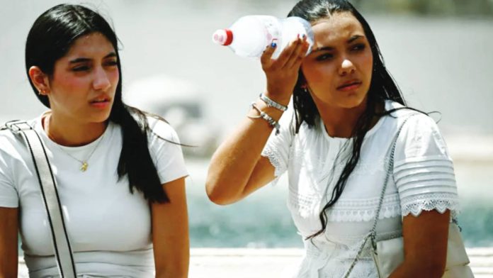 A woman places a bottle filled with ice on her head to cool down at St. Peter’s Square in the Vatican. Temperatures in Italy are yet to peak, with over 40C expected on Monday. GETTY IMAGES