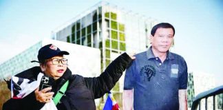 A person stands by a life-size cardboard cutout of former president Rodrigo Duterte during a demonstration in his support outside the International Criminal Court, where he faces trial for charges of crimes against humanity, in The Hague. Photo by Simon Wohlfahrt / AFP