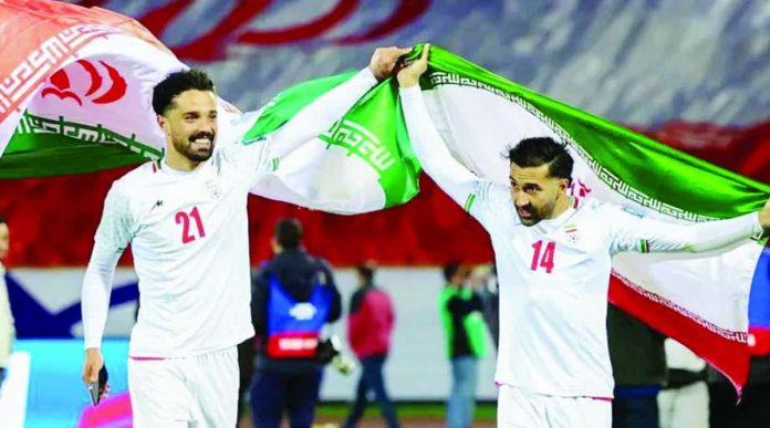 Iran_copy_compressed_resized Iran’s players Omid Norafkan and Saman Ghoddos celebrate after a qualifying match. AFP VIA GETTY IMAGES