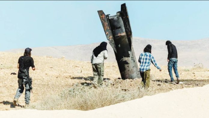 Israel Israeli settlers stand next to part of an Iranian ballistic missile protruding from the ground in the Israeli-occupied West Bank. REUTERS
