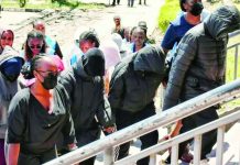 Kenya to charge students with murder over deadly school fire Several hooded and masked students, accompanied by adults, walk up courthouse steps under police escort. They are arson suspects in a fatal school fire. REUTERS