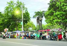 Ambulant vendors sell food and other items along North Capitol Road in Bacolod City. The Negros Occidental provincial government has requested the removal of vendors in the area, citing concerns over traffic, sanitation and security, while city officials maintain that the vendors are operating under permits issued pursuant to the city's Vending Regulation Ordinance. BCCO