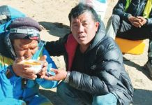 Dawa Sherpa (left), who was feared dead after going missing on Everest last week, has been found. He is shown here drinking from a bowl while being helped by a rescuer. SAGARMATHA POLLUTION CONTROL COMMITTEE