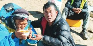 Dawa Sherpa (left), who was feared dead after going missing on Everest last week, has been found. He is shown here drinking from a bowl while being helped by a rescuer. SAGARMATHA POLLUTION CONTROL COMMITTEE